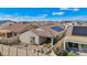 Aerial view of the backyard, showing desert landscape, a paved patio with a fire pit, and a fenced perimeter at 10841 W Nosean Rd, Peoria, AZ 85383