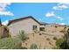 This desert backyard with its agave and cactus landscaping blends with the natural desert environment at 10841 W Nosean Rd, Peoria, AZ 85383