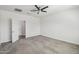 Bedroom features neutral carpeting, a ceiling fan, and a doorway to an adjoining room at 10841 W Nosean Rd, Peoria, AZ 85383