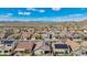 Aerial view of a residential community showcasing diverse home styles and solar panels against a mountain backdrop at 10841 W Nosean Rd, Peoria, AZ 85383