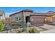 Charming single-story home featuring desert landscaping, tile roof, and paved driveway at 10841 W Nosean Rd, Peoria, AZ 85383