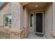 Close-up shot of front entrance, showcasing stone accents, a window, and a stylish front door at 10841 W Nosean Rd, Peoria, AZ 85383