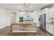 Kitchen featuring a center island with a wood facade, stainless steel appliances, and granite counters at 10841 W Nosean Rd, Peoria, AZ 85383