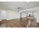 Spacious living room with wood floors and a ceiling fan leads into the kitchen at 10841 W Nosean Rd, Peoria, AZ 85383