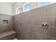 Modern shower with gray tile, built-in bench, and multiple shower heads at 10841 W Nosean Rd, Peoria, AZ 85383