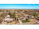 Neighborhood aerial view showcases multiple single-Gathering homes with mature trees and well-maintained yards under a blue sky at 11124 W Southern Ave, Tolleson, AZ 85353