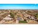 Neighborhood aerial view showcases multiple single-Gathering homes with mature trees and well-maintained yards under a blue sky at 11124 W Southern Ave, Tolleson, AZ 85353