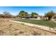 Inviting single-story home with solar panels, a fenced yard, and serene landscaping in a tranquil suburban setting at 11124 W Southern Ave, Tolleson, AZ 85353