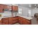 Another view of the kitchen showcasing dark wood cabinets, countertops and floors, and appliances at 11124 W Southern Ave, Tolleson, AZ 85353