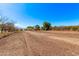 Wide land plot with established trees, offering versatile development opportunities and great potential at 11124 W Southern Ave, Tolleson, AZ 85353