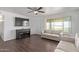 Relaxing living room with neutral couches, ceiling fan, and a large window for natural lighting and backyard views at 11124 W Southern Ave, Tolleson, AZ 85353