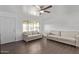 Bright living room featuring a ceiling fan, neutral couches, wood floors, and a large window for ample light at 11124 W Southern Ave, Tolleson, AZ 85353