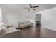 Bright living room with hardwood floors, neutral paint, and modern ceiling fan at 11124 W Southern Ave, Tolleson, AZ 85353