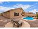 Relaxing backyard with a pool, waterfall, desert landscaping, and lounge chairs at 12787 S 175Th Ave, Goodyear, AZ 85338