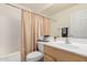 Well-lit bathroom features a shower-tub combination, ample counter space, and a large mirror at 12787 S 175Th Ave, Goodyear, AZ 85338