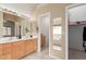 Bathroom featuring double sinks, a vanity, and a walk in closet at 12787 S 175Th Ave, Goodyear, AZ 85338