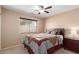 Cozy bedroom featuring a ceiling fan, natural light, and a comfortable bed at 12787 S 175Th Ave, Goodyear, AZ 85338