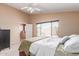 Sunlit primary bedroom featuring carpet floors and ensuite bathroom at 12787 S 175Th Ave, Goodyear, AZ 85338