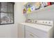 Functional laundry room with washer, dryer, and shelving for storage at 12787 S 175Th Ave, Goodyear, AZ 85338