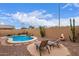 Beautiful backyard features a pool, waterfall feature, desert plants, and lounge chairs at 12787 S 175Th Ave, Goodyear, AZ 85338