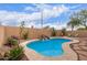 Private backyard oasis with a sparkling pool, waterfall feature, and desert landscaping at 12787 S 175Th Ave, Goodyear, AZ 85338