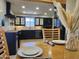 Dining area next to a stylish kitchen with black cabinets at 12807 N 21St Dr, Phoenix, AZ 85029