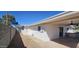 Exterior view of a well-kept home featuring a covered patio, exterior entrance and stone walkway along the side at 12807 N 21St Dr, Phoenix, AZ 85029