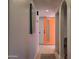 Hallway with a vibrant orange door and modern decor at 12807 N 21St Dr, Phoenix, AZ 85029