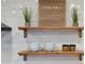 A rustic wood floating shelf adds style and character to the subway tile in this renovated kitchen at 12807 N 21St Dr, Phoenix, AZ 85029