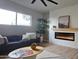 Inviting living room featuring a modern fireplace, wood floors and large windows for plenty of natural light at 12807 N 21St Dr, Phoenix, AZ 85029