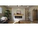 Bright living room with wood floors, modern fireplace, wood mantle, decorative plants and neutral decor at 12807 N 21St Dr, Phoenix, AZ 85029