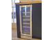 Modern built in wine fridge with clear door and internal light, perfect for entertaining guests at 12807 N 21St Dr, Phoenix, AZ 85029