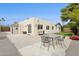 Spacious backyard with a concrete patio, a table and chairs, and lush landscaping, creating a perfect outdoor living space at 12809 N 50Th St, Scottsdale, AZ 85254