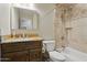 Bathroom with a granite countertop, wood cabinets, and a tiled shower and tub combo at 12809 N 50Th St, Scottsdale, AZ 85254