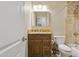 Bathroom featuring a granite countertop, wooden cabinets, and a tiled shower and tub combo at 12809 N 50Th St, Scottsdale, AZ 85254