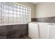 Bathroom featuring glass block window and accessible tub at 12809 N 50Th St, Scottsdale, AZ 85254