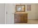 Bathroom with natural-tone cabinetry, decorative mirror, and earth tone tiling at 12809 N 50Th St, Scottsdale, AZ 85254