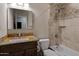 Well-maintained bathroom featuring a single vanity, shower-tub combo, and tiled walls at 12809 N 50Th St, Scottsdale, AZ 85254