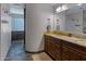 Bathroom featuring granite countertops, a double vanity, and tiled walk-in shower at 12809 N 50Th St, Scottsdale, AZ 85254