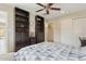 Bedroom with carpet floors, a ceiling fan, and built-in shelving at 12809 N 50Th St, Scottsdale, AZ 85254