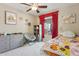 Cozy bedroom with a ceiling fan, a comfortable chair, and bright natural light at 12809 N 50Th St, Scottsdale, AZ 85254