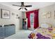 Charming bedroom featuring a ceiling fan, colorful bedding, and lots of natural light at 12809 N 50Th St, Scottsdale, AZ 85254