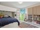 Bright bedroom featuring a bunk bed, colorful rug, and plenty of built-in storage at 12809 N 50Th St, Scottsdale, AZ 85254