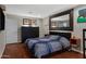 Cozy bedroom featuring hardwood floors, large mirror, and dark wood accents at 12809 N 50Th St, Scottsdale, AZ 85254