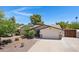 Home featuring solar panels, desert landscaping, and a two-car garage at 12809 N 50Th St, Scottsdale, AZ 85254