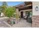 Inviting covered front porch with stone pillars, pavers, and comfortable seating for relaxing outdoors at 12809 N 50Th St, Scottsdale, AZ 85254