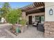 Charming front porch with a pergola, stone accents, and comfortable seating for relaxing outdoors at 12809 N 50Th St, Scottsdale, AZ 85254