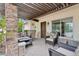 Inviting front porch with stone pillars, shaded seating, and views of the landscaped yard at 12809 N 50Th St, Scottsdale, AZ 85254