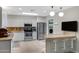 Beautiful kitchen with white cabinetry, stainless steel appliances, granite countertops, and bar stool seating at 12809 N 50Th St, Scottsdale, AZ 85254