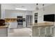 Beautiful kitchen with white cabinets, granite countertops, stainless appliances, island with seating, and tile floors at 12809 N 50Th St, Scottsdale, AZ 85254
